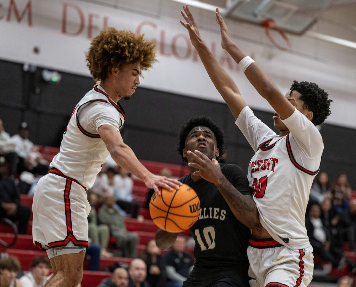 The Jesuit Marauders' Xavier Owens (30) defends as Brandon Williams (1) knocks the ball away from the Granite Bay Grizzlies' Darnell Turner Jr. (10) in the first half on Wednesday, Jan. 7, 2026, in Carmichael.