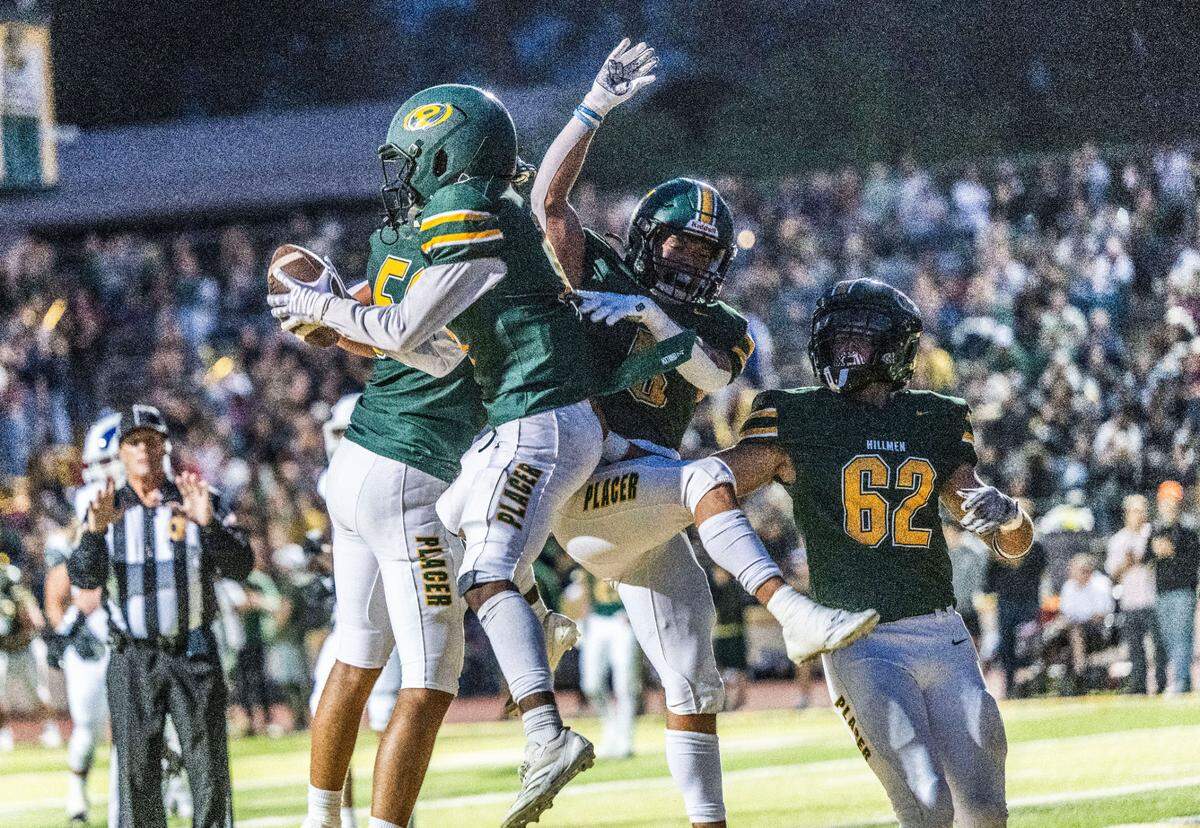 The Placer Hillmen’s Baylor Kelley (11) celebrates with teammates after scoring the first touchdown against the Casa Roble Rams on Friday, Aug. 23, 2024, in Auburn during the season opener for both teams.