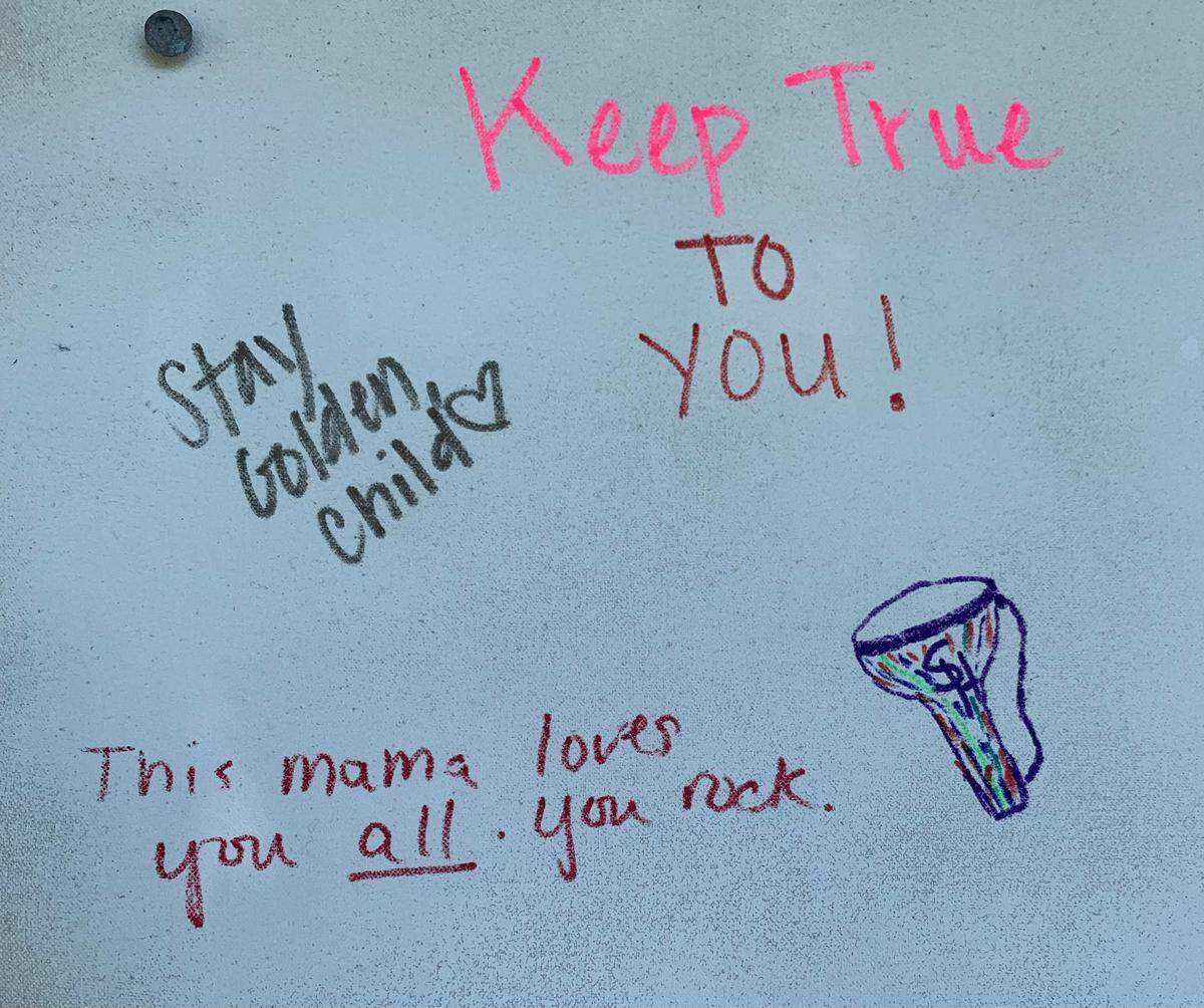 Inclusive messages are written on a poster board at Placer Pride.