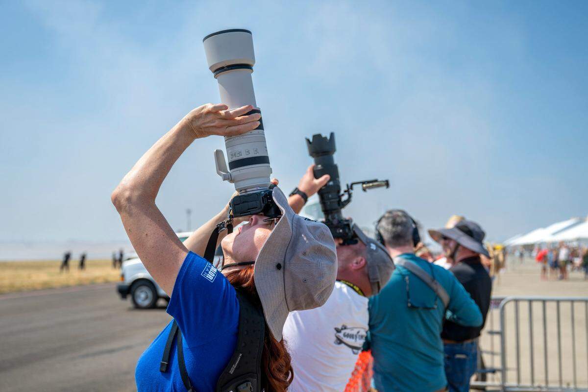 Nicole Martin points her camera towards the sky in hopes of getting a photo of the U.S. Air Force Thunderbirds on Friday, the preview day for the Beale Air & Space Expo.