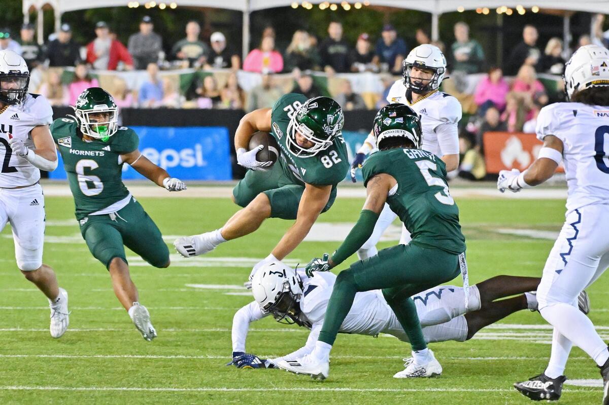 The Sacramento State Hornets’ Coleman Kuntz (82) tries to avoid the tackle by Northern Arizona Lumberjacks’ Zach Lewis (3) in the second half of the NCAA football game at Hornet Stadium on Saturday, Sept. 30, 2023.