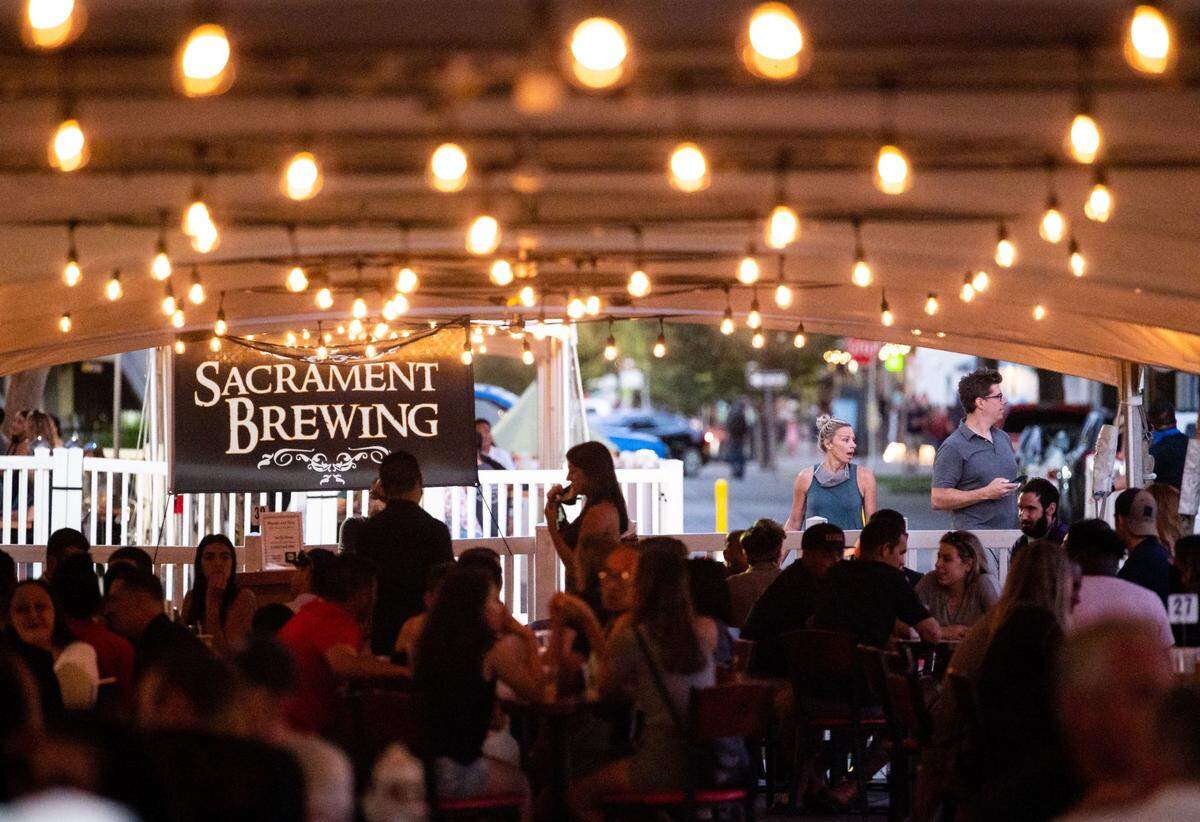 Drinkers and diners enjoy service under tents when the block of R Street was closed to vehicular traffic in 2020.