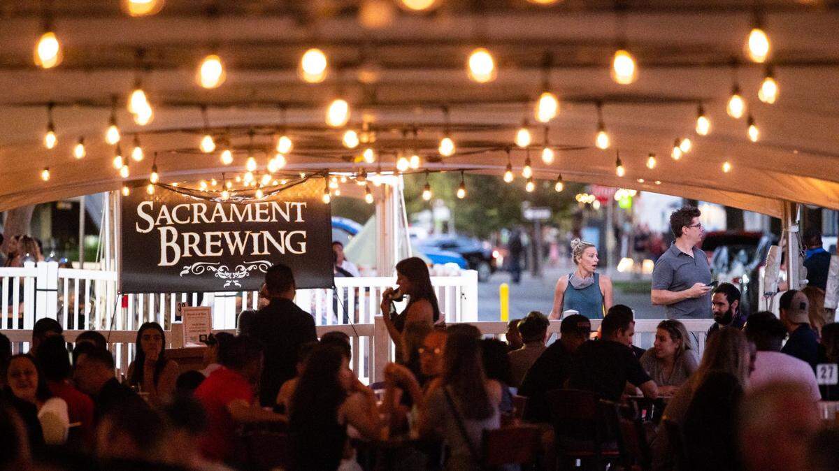 Drinkers and diners enjoy service under tents when the block of R Street was closed to vehicular traffic in 2020. downtown Sacramento. The closure was announced to allow restaurants and bars the room to seat outdoors in adherence with part of the coronavirus prevention protocols.