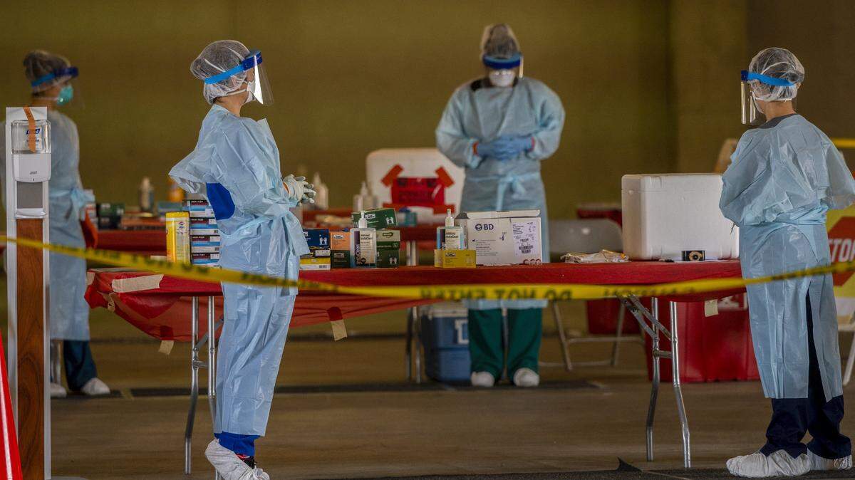 Nurses work in pairs as they wait for patients for coronavirus testing at Cal Expo in Sacramento on Wednesday, April 15, 2020.