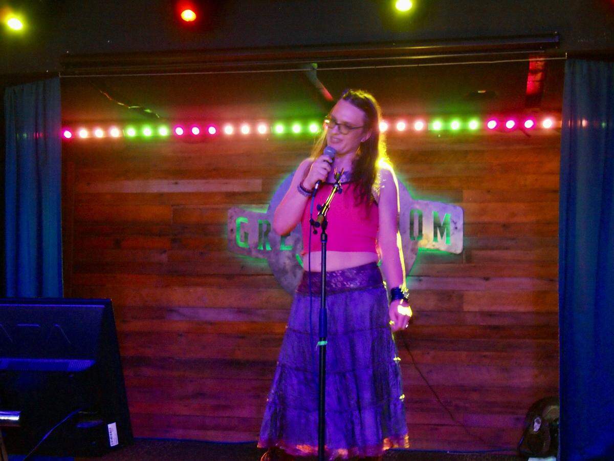 Justine Robbins, a trans woman from Placerville, performs Patrick Wolf’s “Hard Times” at the Green Room Social Club. She and her spouse celebrated their 12th wedding anniversary with Placerville’s queer community and allies.