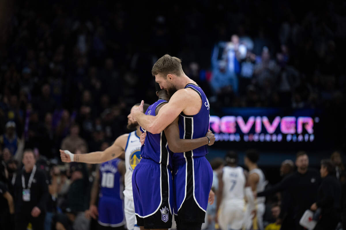 Sacramento Kings center Domantas Sabonis (11) embraces teammate De’Aaron Fox (5) following the victory over the Golden State Warriors on Wednesday at Golden 1 Center.