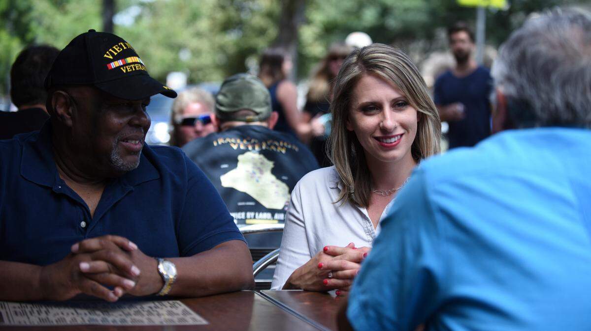 In this August 2018 photo provided by the Katie Hill Campaign, Katie Hill, center, who is running for a seat in Congress meets with longtime supporter Harry Reed.