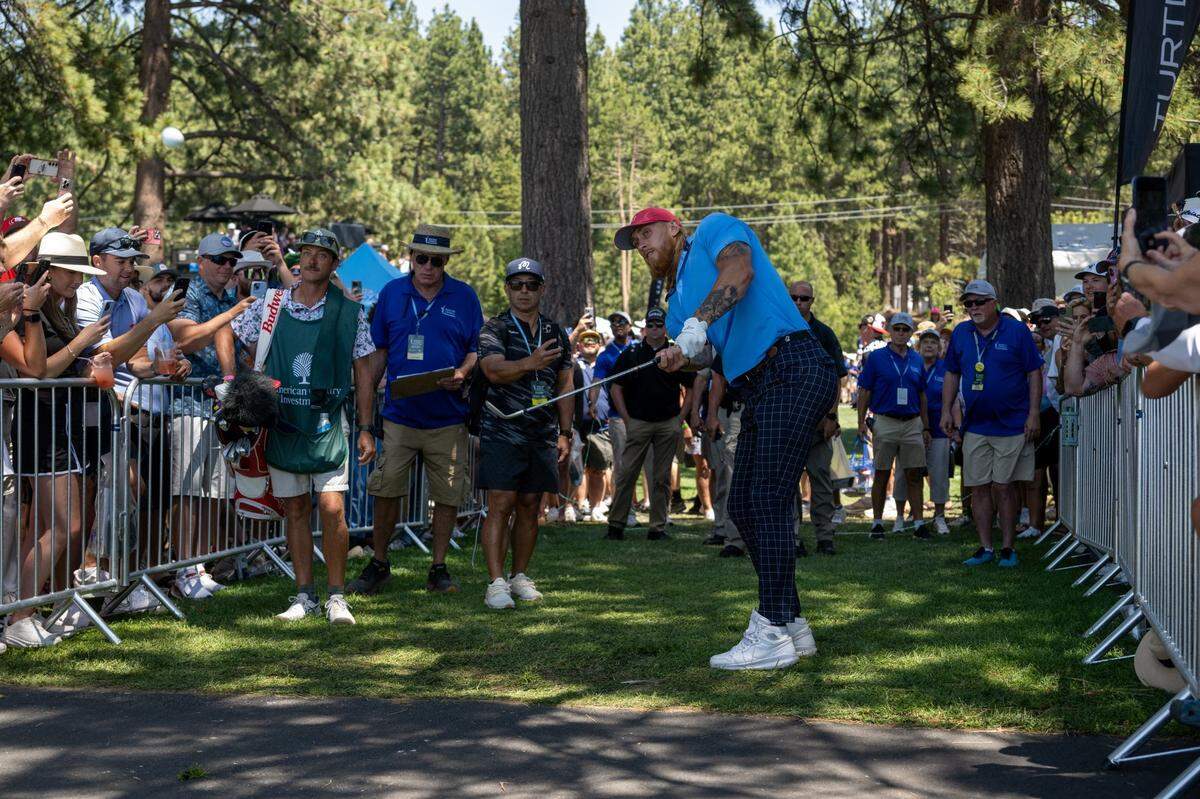 The San Francisco 49ers’ George Kittle hits from the rough onto the 17th green during the American Century Championship celebrity golf tournament at Edgewood Tahoe Resort in Stateline, Nev., on Friday.