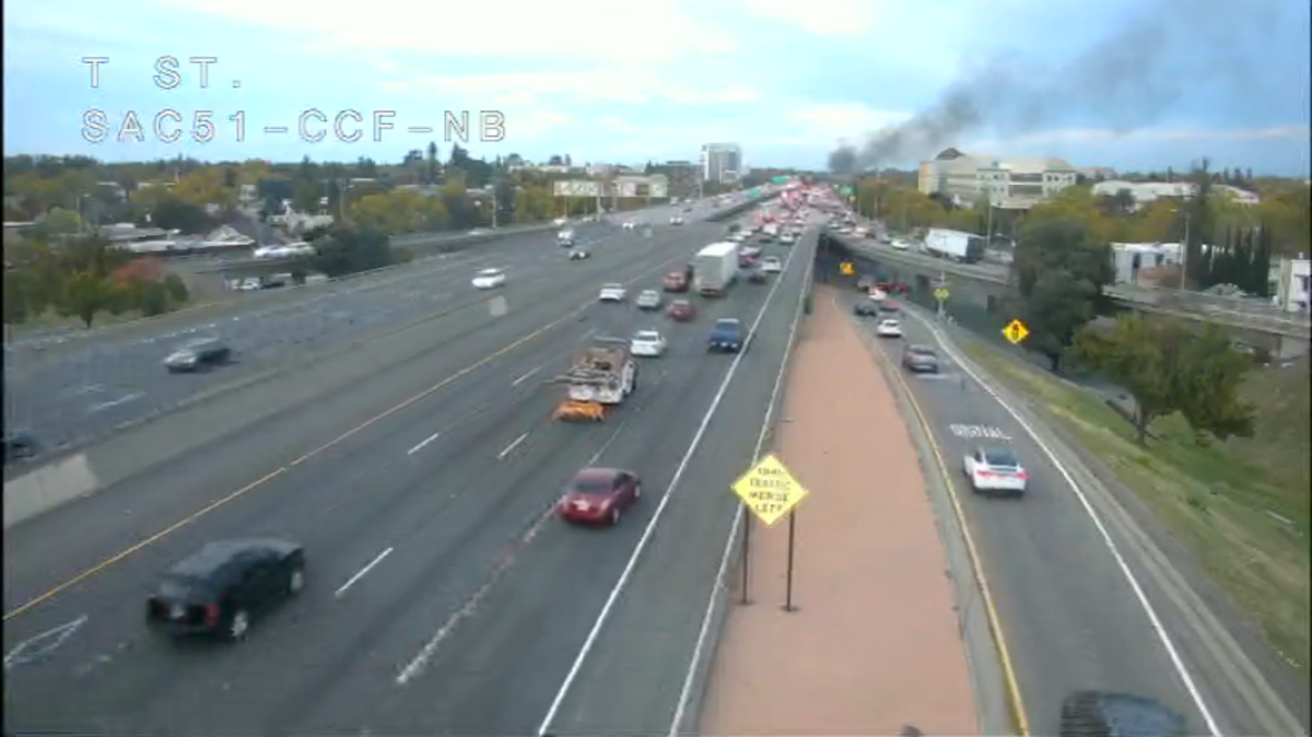 At least one vehicle caught fire after a crash Tuesday afternoon on the northbound Capital City Freeway near N Street in Sacramento, stalling traffic.