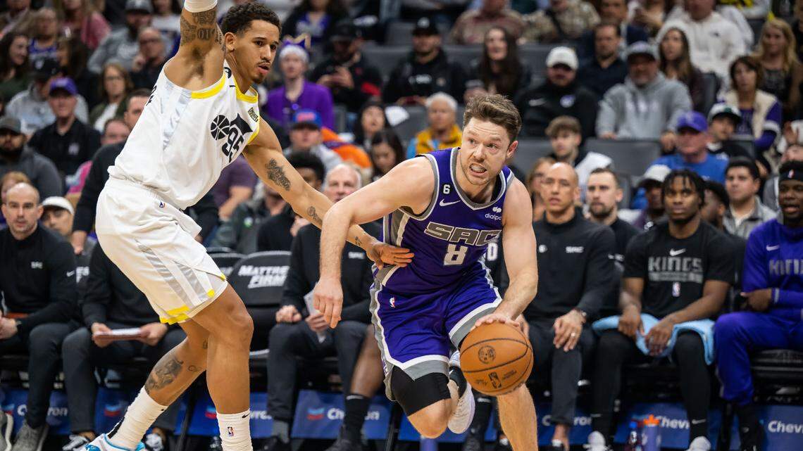 Sacramento Kings guard Matthew Dellavedova (8), right, dribbles past Utah Jazz forward Juan Toscano-Anderson (95) during the second half of the NBA basketball game Saturday, March 25, 2023, at Golden 1 Center. The Kings beat the Jazz, 121-113.