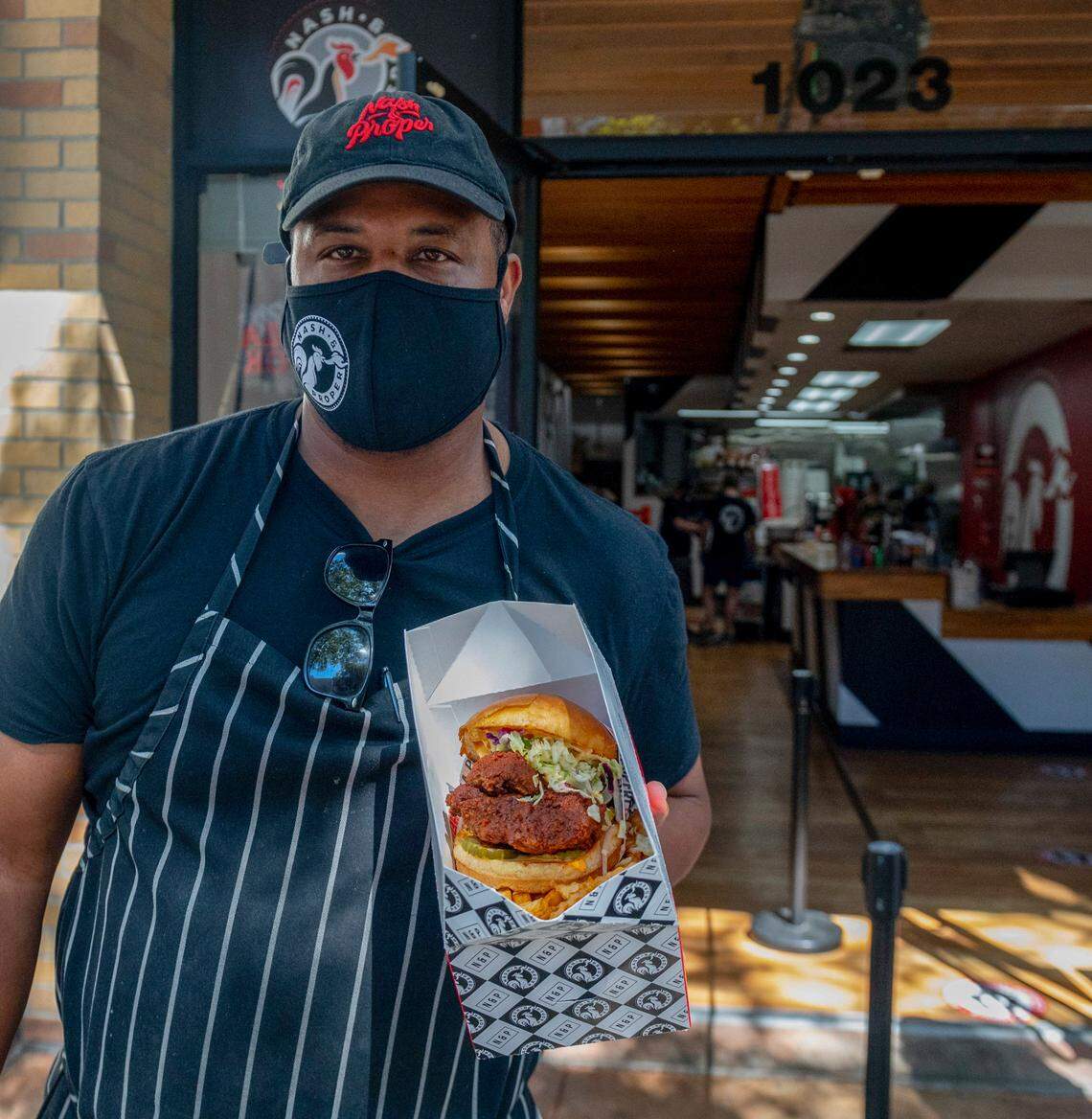 Owner Cecil Rhodes holds the most popular menu item at Nash and Proper, which is one of the many restaurants taking part in this year’s Dine Downtown. “The Sammich” is a fried crispy chicken thigh, slaw, fuego sauce, and pickles on a butter bun.