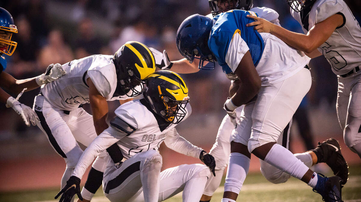 Del Campo’s Foy Reynolds III, right, strips the ball for a turnover against Del Oro during the second quarter of the high school football game Friday, Aug. 27, 2021, at Del Campo High School in Fair Oaks.