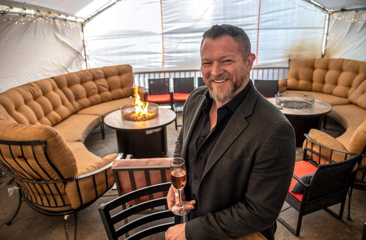 Matthew Oliver, owner of three restaurants in Placer County — House of Oliver, Oliver’s Brewhouse and Grill, and Oliver’s Antler Steakhouse — stands inside his tented outdoor wine lounge at House of Oliver on Monday. “Placer County’s policies are the reason we are still open today,” he said.