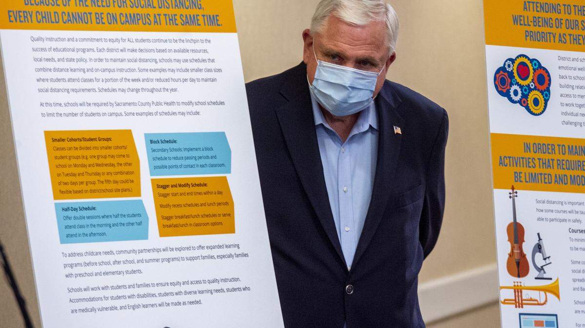 Sacramento County Superintendent of Schools Dave Gordon stands on Tuesday, June 2, 2020, by a poster of guidelines for reopening schools, and recommendations on extracurricular activities, for the 2020-21 school year during the coronavirus pandemic. Gordon criticized inconsistent online learning schedules in the Sacramento City Unified School District.