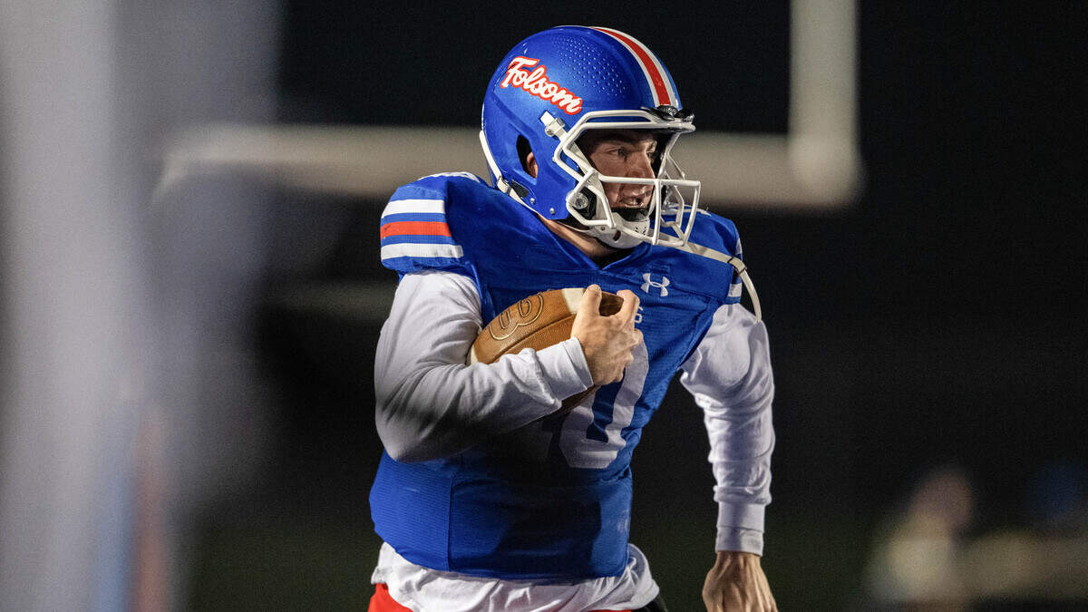 Folsom Bulldogs quarterback Brody Rudnicki (10) rushes down the sideline for 50 yards against the Riordan Crusaders In a CIF Northern California Regional Division 1-AA football championship game in Folsom on Friday, Dec. 5.