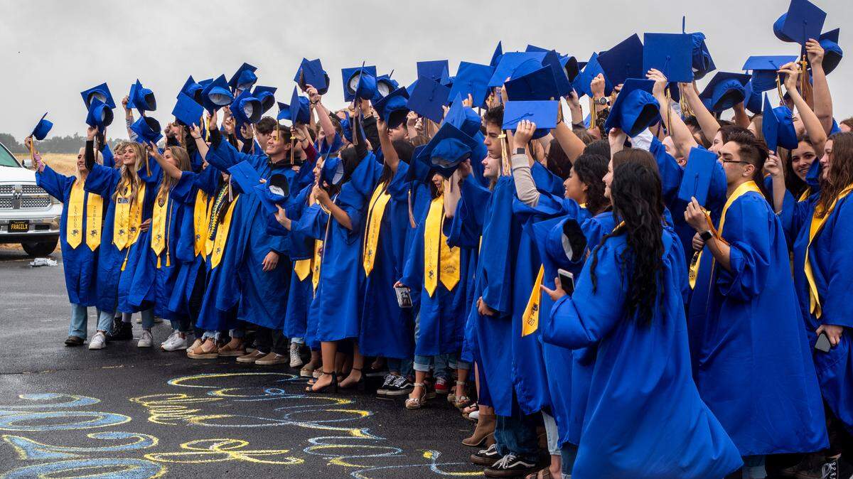 Lincoln High School seniors wave their caps in the air Sunday, May 17, 2020, in Lincoln while they get their photos taken during the Class of 2020 Senior Photo Day.