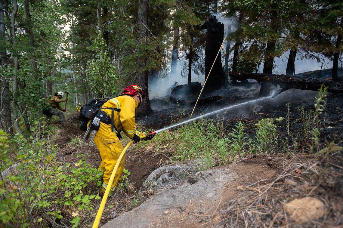 El Dorado County firefighters protect homes near Snowflake Drive in Christmas Valley on Tuesday, Aug. 31, 2021, as the Caldor Fire burned into the Tahoe Basin.