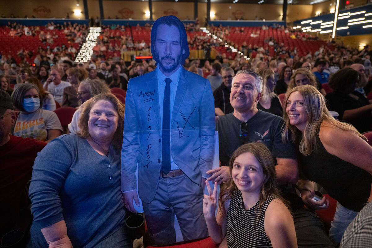 Keanu Reeves fans Patti Dias, left, Meghan Kanotz, kneeling, Rich Walker and Terrie Kanotz pose with a cardboard cutout of the star before his band Dogstar takes the stage at the Hard Rock Live Sacramento near Wheatland on Saturday, Sept. 14, 2024.