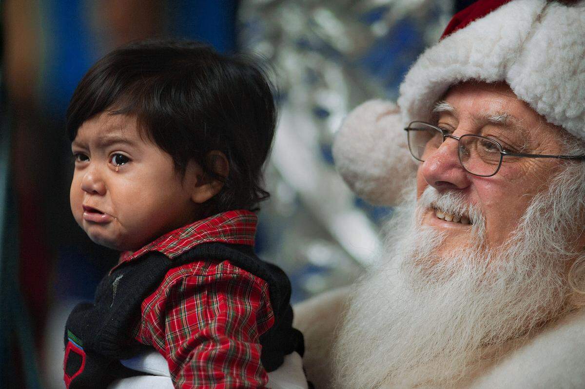 One-year-old Angel Cardoza, of Diamond Springs, sheds a tear on the lap of Paolo “’Santa Paul” Ferro at Arden Fair mall in Sacramento in 2010. Santa said he is seeing longer lines this season and is pleasantly surprised. “The lines are much better this year than last. There’s more happiness.”