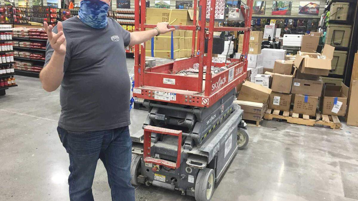 Store manager Aaron Loucks talks on the floor of the new Sportsman’s Warehouse in Elk Grove, Calif., on Monday, Nov. 15, 2021, as crews prepare for the storeâs Saturday opening. The specialty outdoor retailer’s 40,000 square-foot store is located in the Laguna Gateway shopping center at Laguna and Big Horn boulevards.