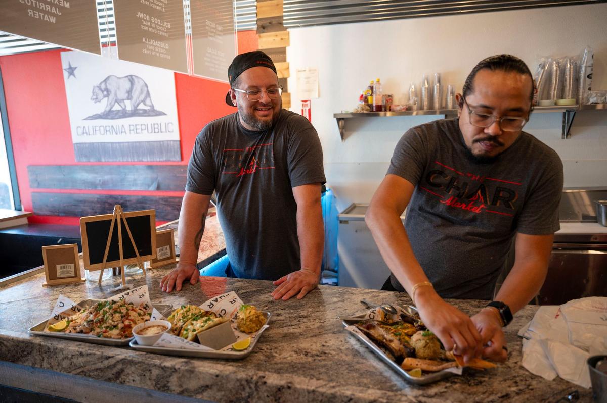 Owners Shane Cichy, left, and Noah Corsey stand behind the counter at Char Market in Carmichael on Thursday, Aug. 28, 2024.