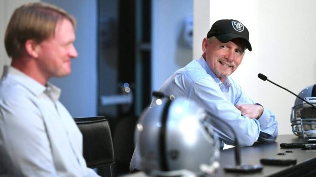 Oakland Raiders General Manager Mike Mayock smiles while sitting next to coach Jon Gruden as they talk about the NFL Draft on Thursday, April 25, 2019.