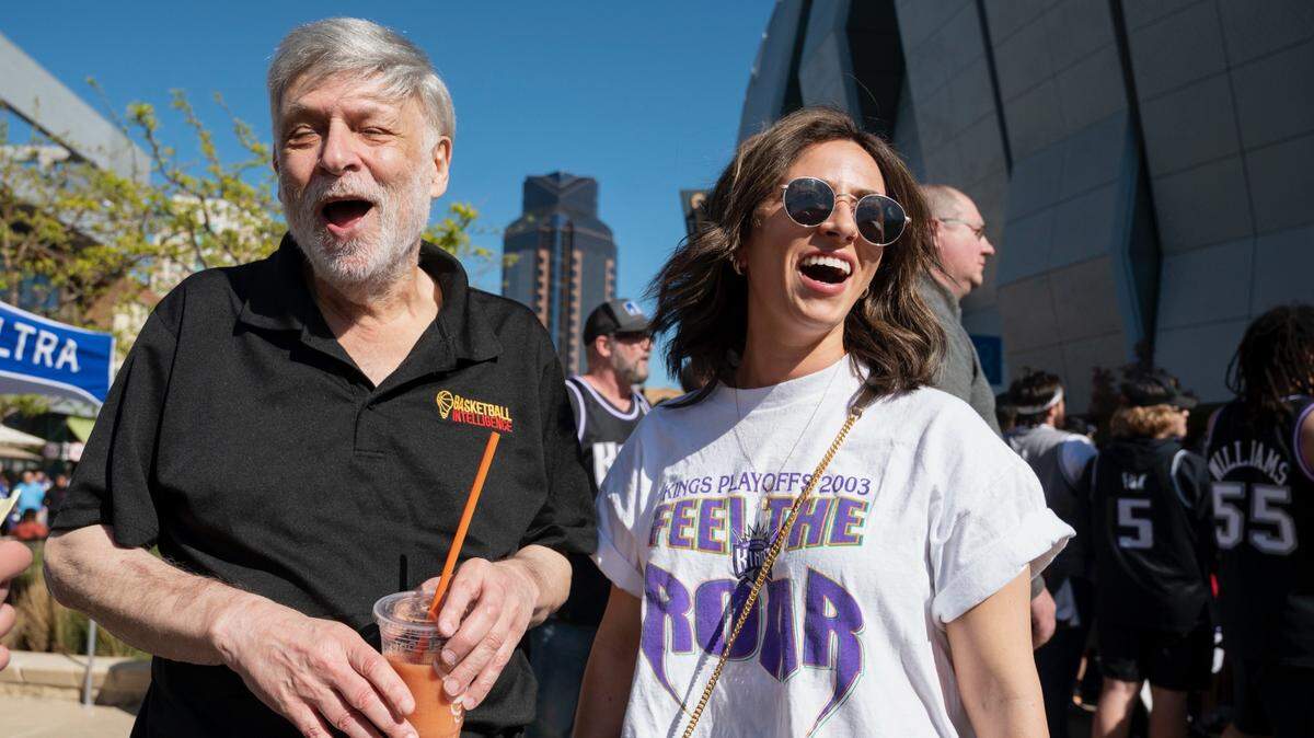 Sacramento Kings fans Ray LeBrov and daughter Lauren LeBrov laugh outside Golden 1 Center before Game 1 of the team’s NBA playoff series against the Golden State Warriors on Saturday. Lauren’s vintage Kings playoff T-shirt dates from 2003.