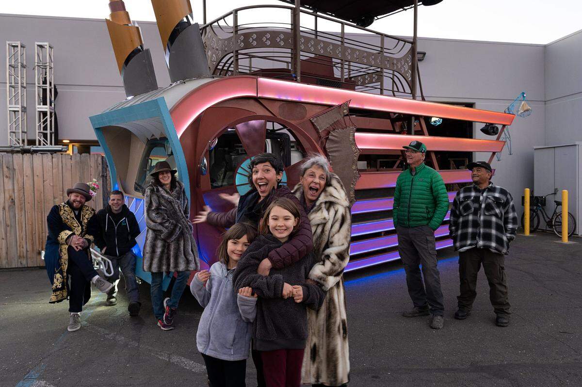 Kimberly Medici, center left, poses with daughters Talulah, 6, Mylah, 9, and her mother Cindy Medici surrounded by crew members Justin Sawyer, left, Anthony Saad, Michele LoPresti, Chris Coburn and Bruce Taitague. The group built a float called DecoFish, which will participate in The City of Trees Parade, a Mardi Gras parade event planned for Feb. 26.