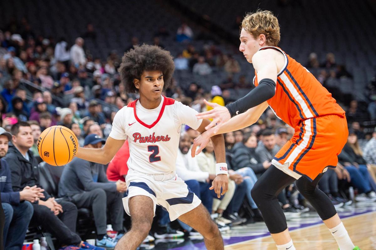 San Joaquin Memorial Panthers guard Abram Potts (2) passes the ball around Pacifica Christian Tritons Parker Strauss (3) in the second half in the CIF State Division II Boys Basketball Championship on Saturday, March 11, 2023, at Golden 1 Center in Sacramento. The Panthers defeated the Tritons 58-47.