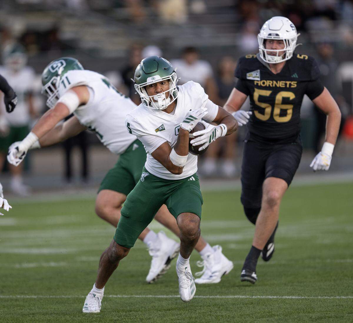 Cal Poly Mustangs wide receiver Jordan Garrison (5) runs after a catch against the Sacramento State Hornets defense in the first half on Saturday in Sacramento.