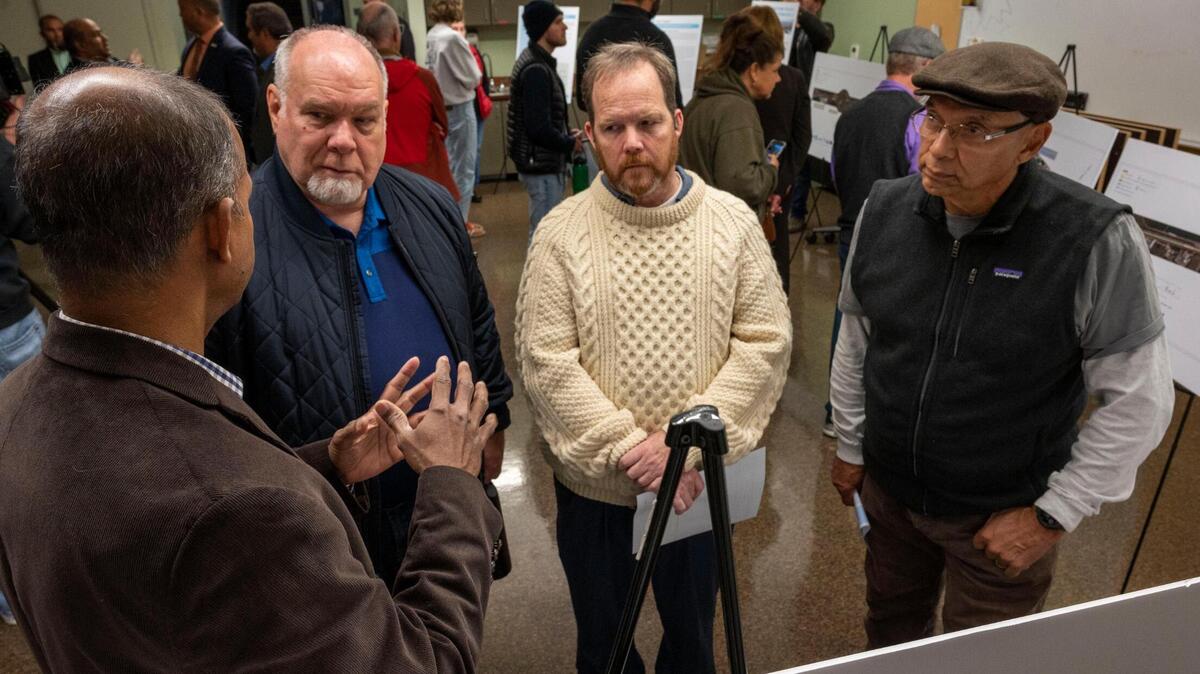 Caltrans regional project manager Suthahar, left, explains the proposed $465 million project to construct toll express lanes on Interstate 80 and U.S. Highway 50 in Yolo and Sacramento counties to residents, Kevin Cohee, Brook Gale and Gene Castillo during a community meeting at the West Sacramento Community Center on Tuesday. Caltrans would add a lane in both directions to reduce delays and encourage transit usage, vanpooling and carpooling.