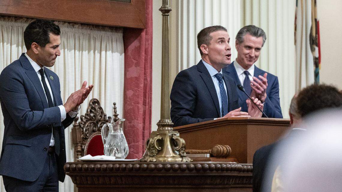 Assembly Speaker Robert Rivas, D-Hollister, left, and Gov. Gavin Newsom, right, applaud newly sworn in Senate president pro tempore Mike McGuire, D-Healdsburg, on Monday, Feb. 5, 2024, at the state Capitol in Sacramento. The three have struggled to lead in unity.