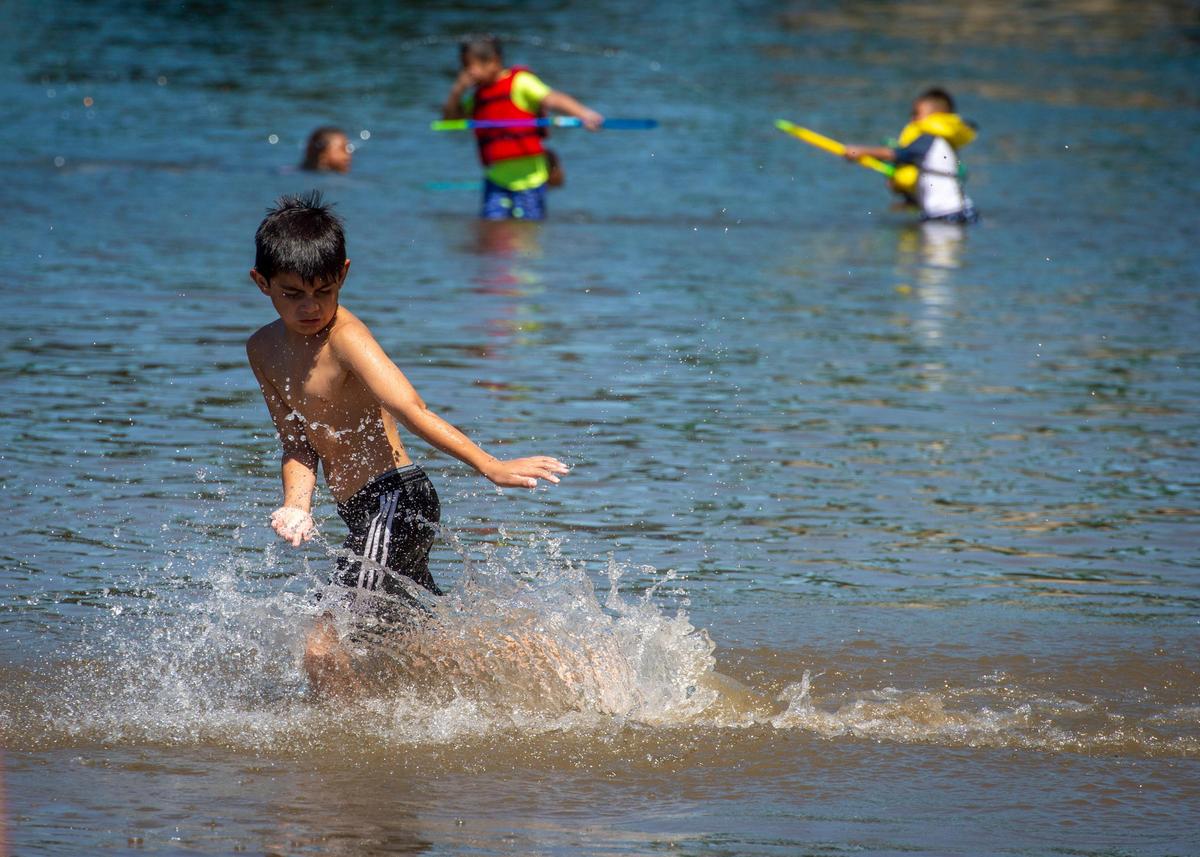 Angel Martinez runs through the water at Tiscornia Beach at Discovery Park on Sept. 1.