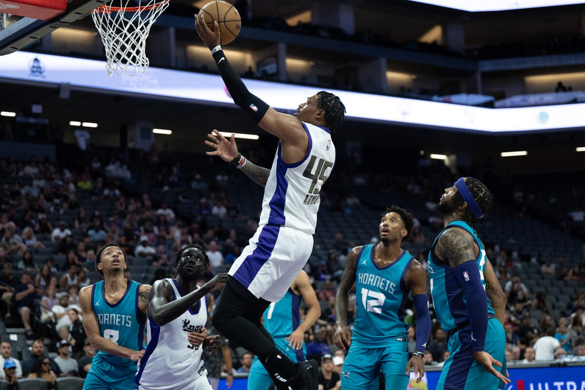 Sacramento Kings forward Adonis Arms drives to the basket past Charlotte Hornets guard Zavier Simpson during a California Classic game Tuesday at Golden 1 Center.