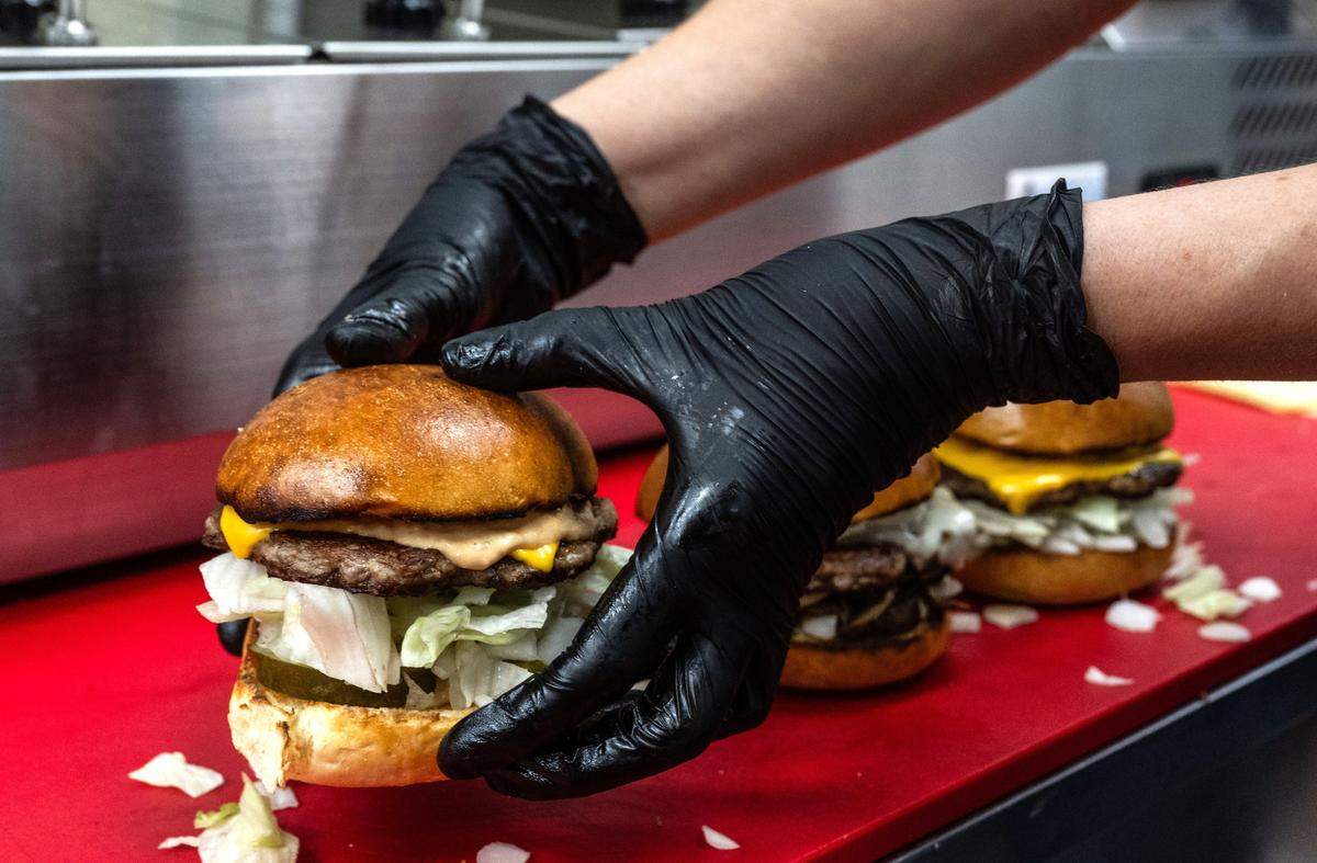 A burger is prepared at Lucky’s Drive-In restaurant on Thursday, March 6, 2025.
