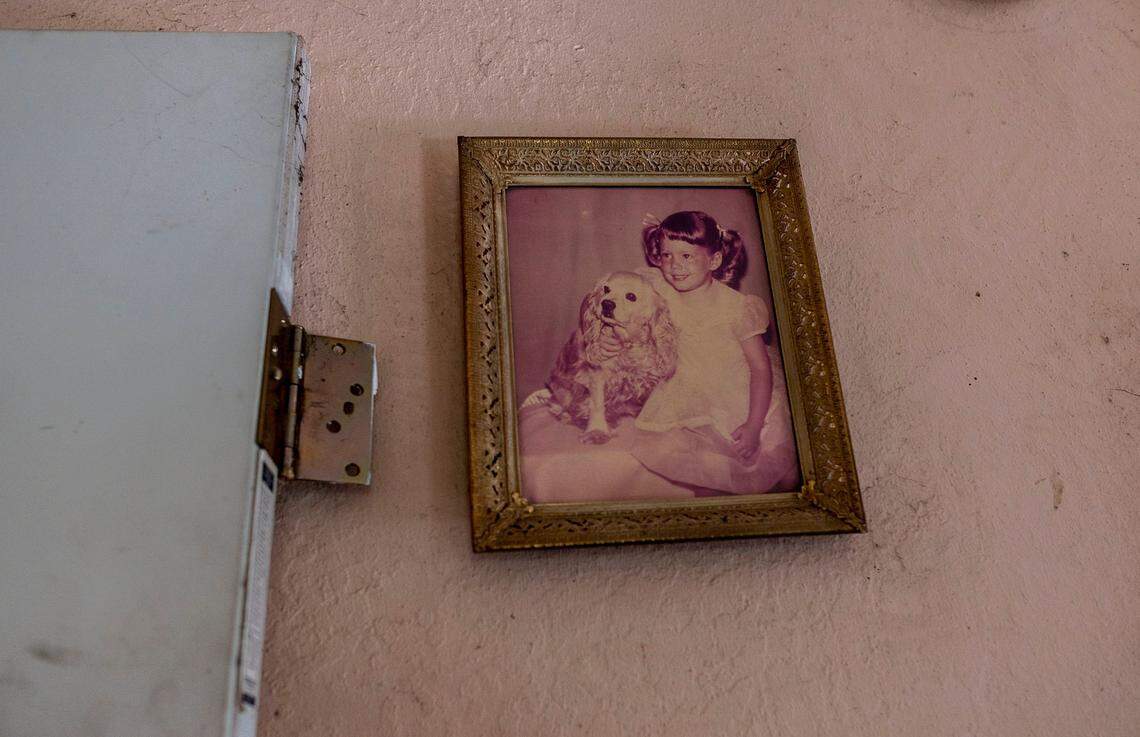 A photo of Linda Siegrist holding her dog when she was a child hangs in her home that is in receivership on Nov. 4. “This house is paid for and I grew up in it,” said Siegrist, who worries she can’t pay for the receiver’s services, which could result in a lien on the property that could force the sale of the home.