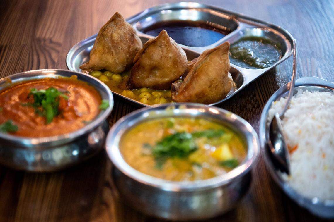 Samosas served on garbanzo beans with tamarind sauce and mint chutney, at top, is ready to serve with other dishes at Jasdeep Singh Purewal’s Hop Junction on June 27, 2020. The restaurant offers a unique combination of craft beers and Indian food on Greenhaven Drive in Sacramentos Pocket neighborhood.