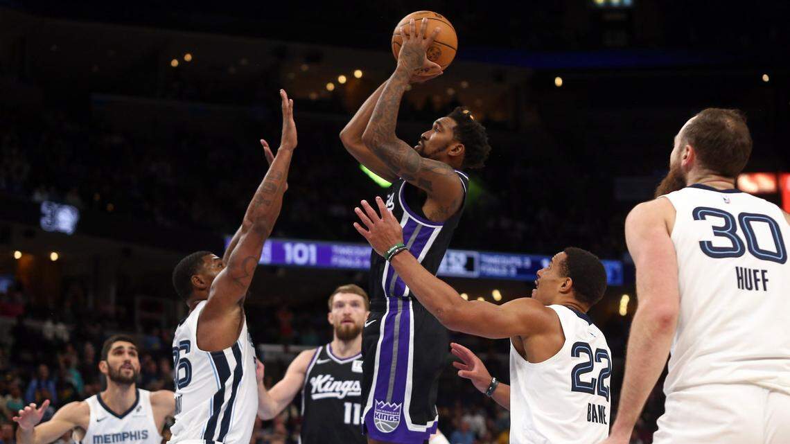Dec 5, 2024; Memphis, Tennessee, USA; Sacramento Kings guard Malik Monk (0) shoots as Memphis Grizzlies guard Marcus Smart (36) and guard Desmond Bane (22) defend during the fourth quarter at FedExForum. Mandatory Credit: Petre Thomas-Imagn Images