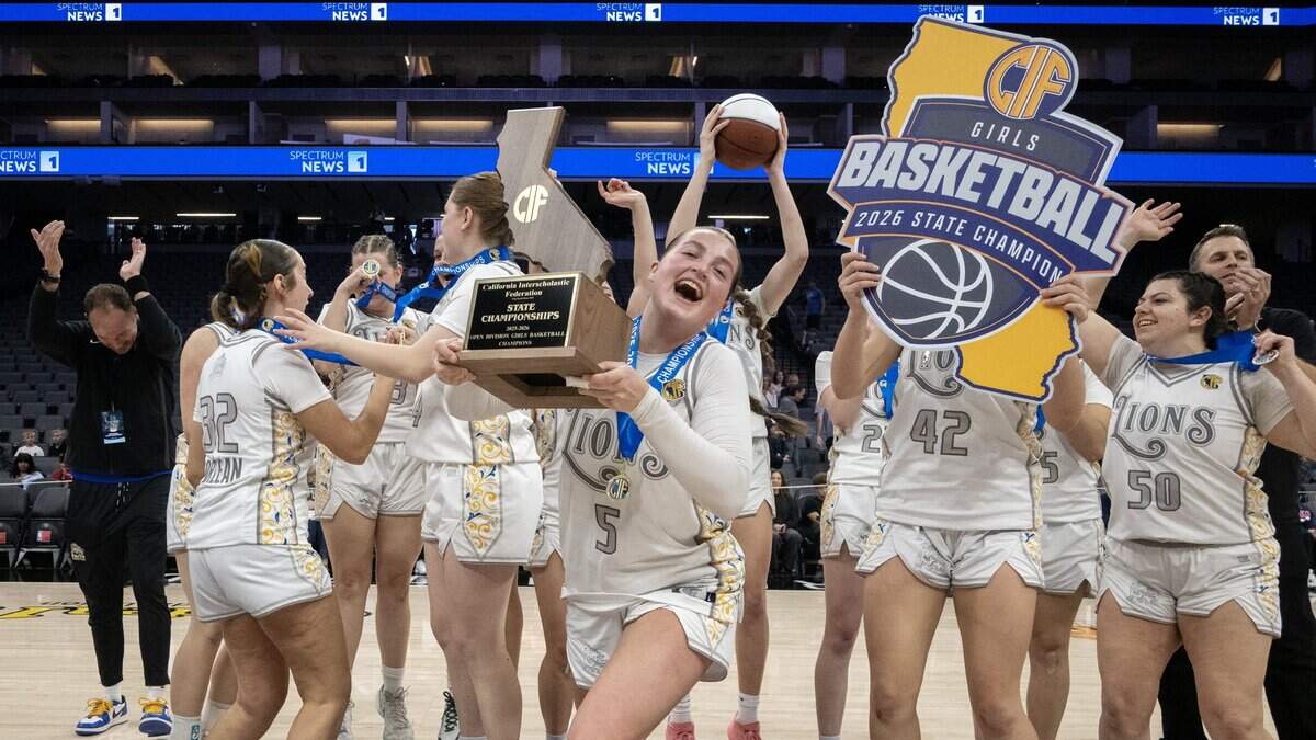 The Faith Christian Lions, led by Lauren Harris (5), celebrate following the 51-37 win over the Palisades Dolphins in the CIF State Division IV girls basketball championship Saturday at Golden 1 Center.