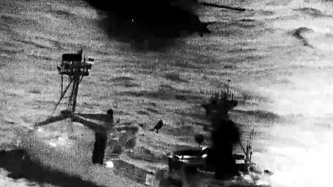 A U.S. Coast Guard helicopter airlifted a crewman who became pinned under a crab pot from a fishing boat off Alaska, officials say.