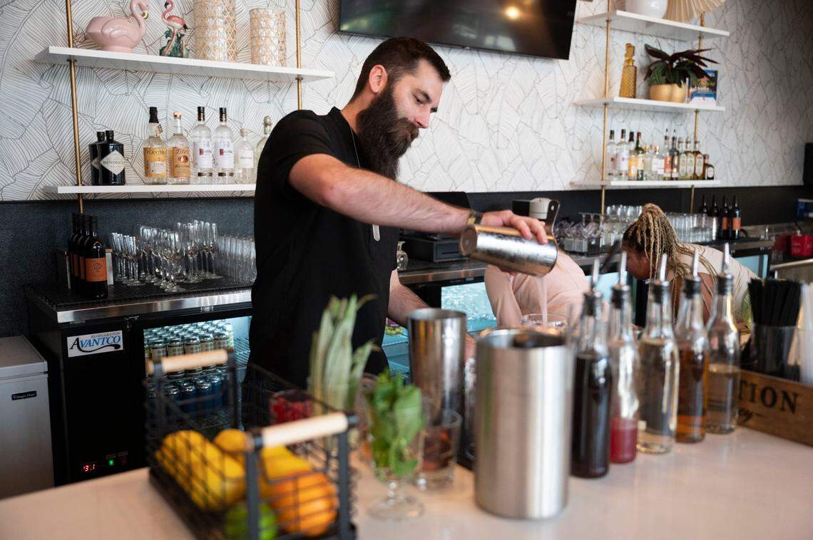 Tyler Arstingstall, a bartender at Cabana Club, mixes a drink during a sneak peek event Wednesday.