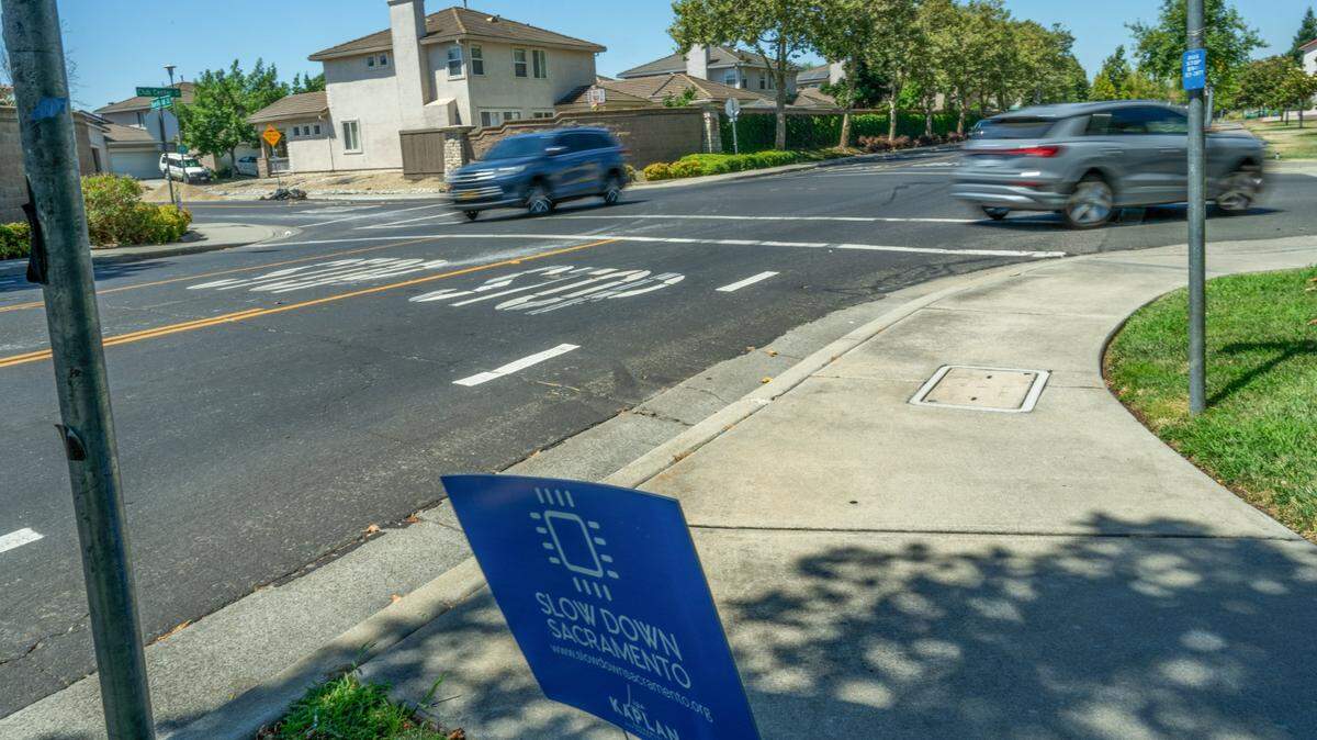 A “Slow down Sacramento” sign stands at an intersection in the city. Fourteen streets are getting reduced speed limits.