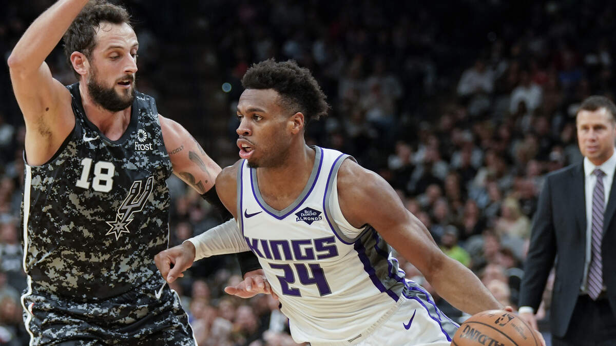 Buddy Hield (24) of the Kings tries to dribble around Marco Belinelli of the Spurs in the first half March 31 in San Antonio. Hield scored 26 points as Sacramento scored its first season sweep of the Spurs and won in San Antonio for the first time since Jan. 20, 2012.