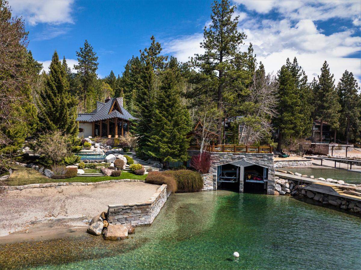 Listing agent Clif Chase calls the compound’s lake amenities “divine”: 370-feet of lake frontage, a sandy beach, stone boathouse with two lifts, three buoy moorings, a private pier and breakwater jetty.
