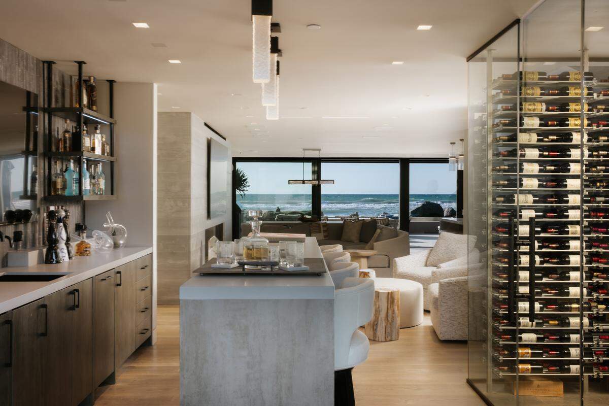 Glass walls frame sweeping Pacific views from nearly every room in this two‑story coastal compound.