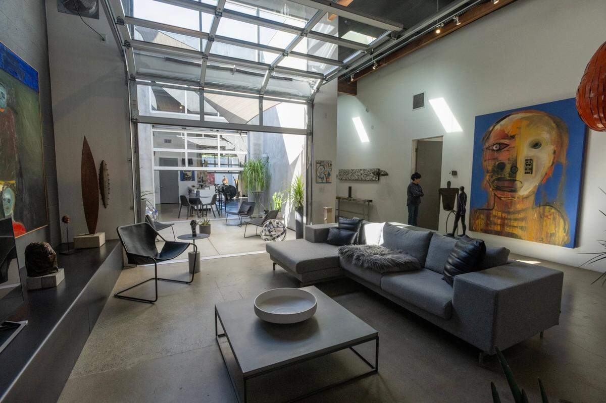 The master bedroom features a glass-roll up door that gives access to the home’s interior courtyard.