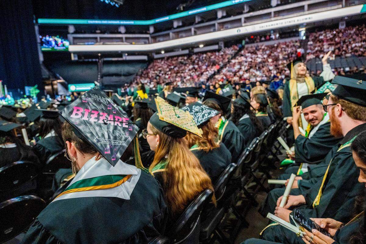 Sacramento State graduates wear decorated mortarboards during one of the school's commencement ceremonies at Golden 1 Center on Friday. The university is celebrating the largest graduating class in its history.