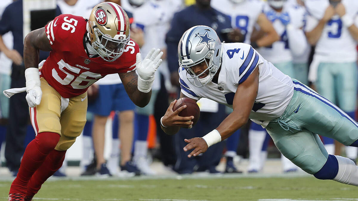 Dallas Cowboys quarterback Dak Prescott (4) dives in front of San Francisco 49ers linebacker Reuben Foster (56) during the first half of an NFL preseason football game in Santa Clara, Calif., Thursday, Aug. 9, 2018.