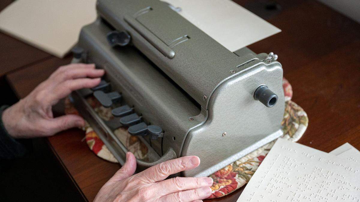 Scott Richmond, former president of the Association of California State Employees with Disabilities, uses a brailler to take notes in his home office in December. 