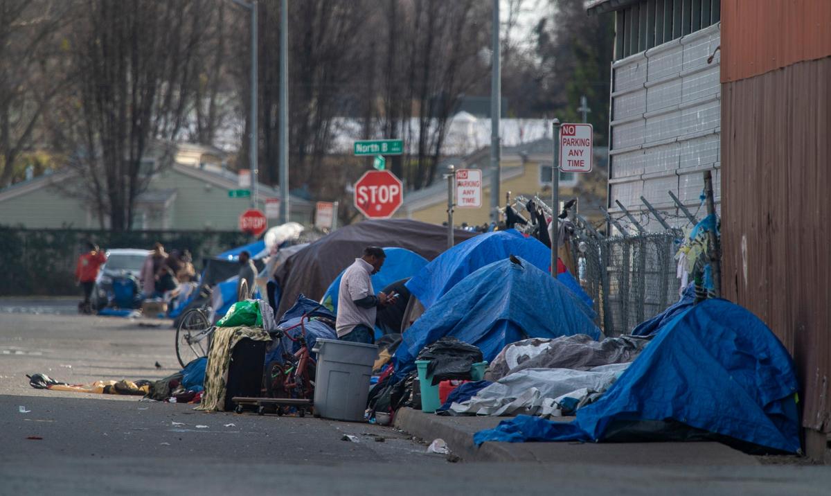 People experiencing homelessness camp along Ahern Street in the River District in February 2019, near where a homeless man was found deceased days before as temperatures dropped to the low 30s.